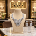 Silver-tone clear stone layered necklace with ornate centrepiece and matching drop earrings