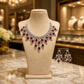 Silver-tone red stone necklace and matching drop earring set with clear stone accents