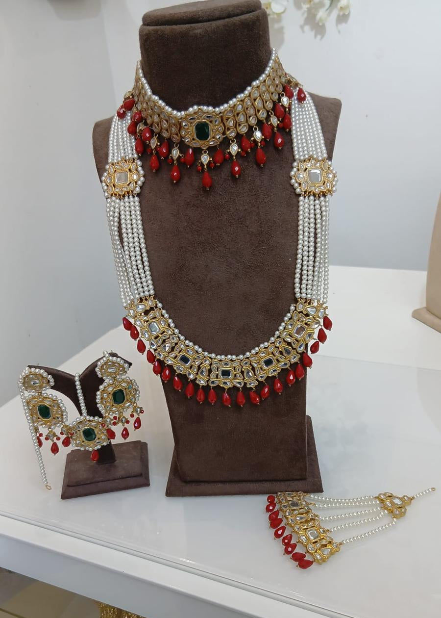 Jewelry set including a necklace and earrings on a brown mannequin and white surface.
